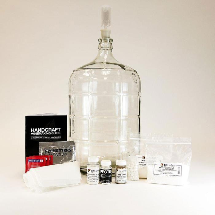 Master Vintner Fresh Harvest 5-Gallon Upgrade, containing a winemakers handbook, 5-gallon glass carboy, straining bag, and various chemicals for cleaning and stabilizing