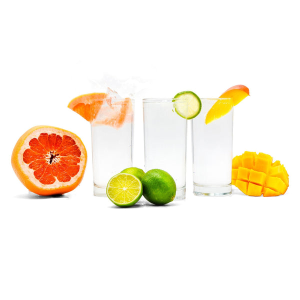 3 glasses of hard seltzer with fruits, grapefruit, limes, and mango.