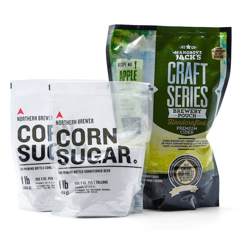 Hard peach and passionfruit cider concentrate in a pouch beside two bags of corn sugar