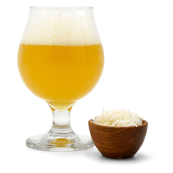 Hula Hop'd Coconut Milkshake IPA in a glass, a bowl of coconut shavings